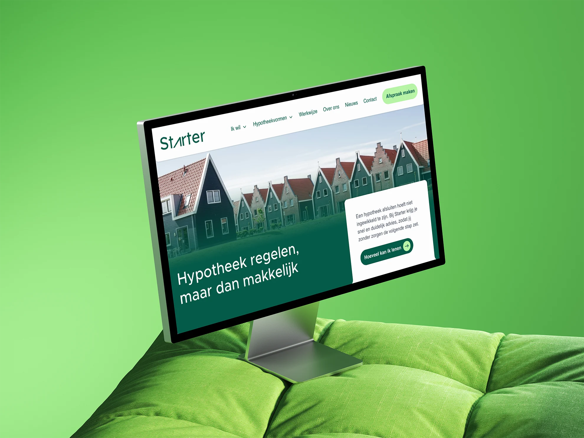 Computerbeeldscherm met een hypotheekwebsite 'Starter', groene achtergrond en huizen op de achtergrond